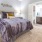 Large well lit bedroom with plush carpets and large windows 