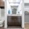 Large well lit bathroom with white accents 