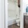Large well lit bathroom with white accents 