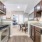 Spacious and well lit kitchen with wood flooring and stainless steel appliances