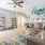 Spacious and well lit living room with wood flooring, large windows and open access to the kitchen